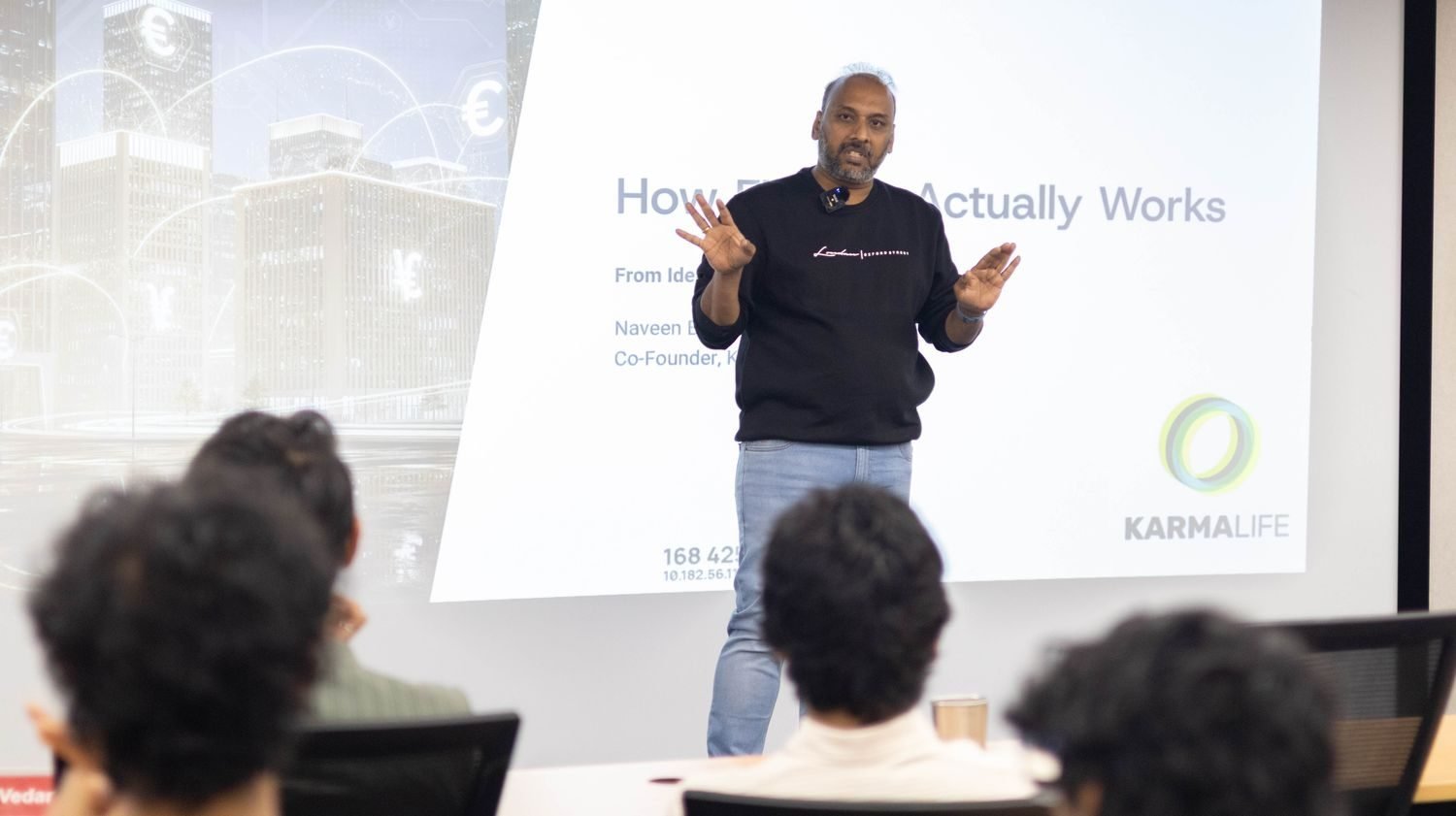 Naveen Budda presenting a slide titled 'How Fintech Actually Works' to Mesa School of Business students, with the KarmaLife logo visible on screen.